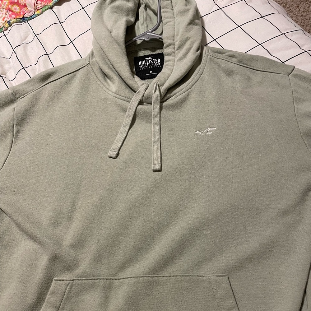 brand new, size medium. the color is a sage green